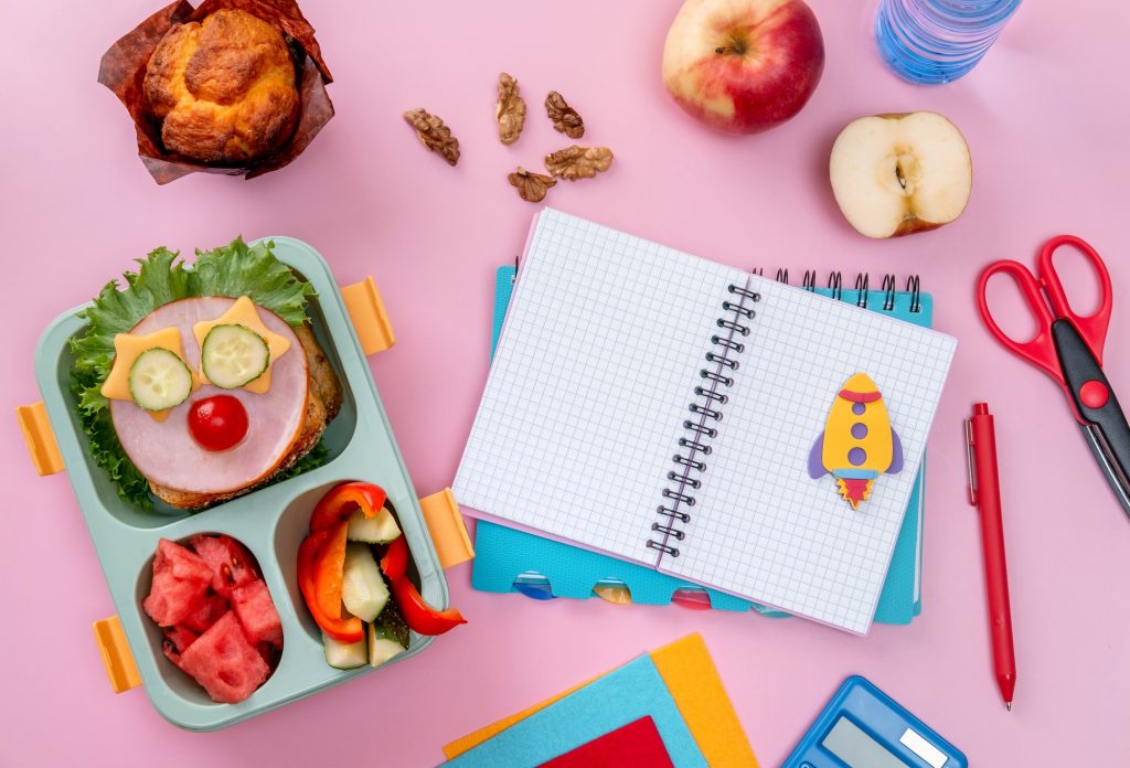 School lunch box for kids with food in the form of funny faces. School lunch box with sandwich